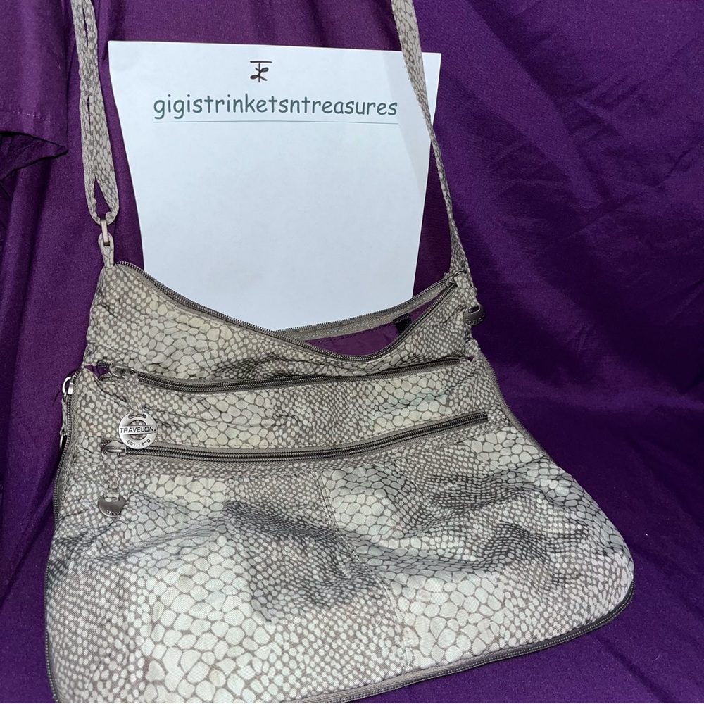 Travelon brand.  Gray snake design. Shoulder bag with multiple compartments.